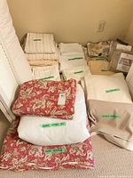 Grouped bedding showing bedspread, duvet cover, sheets, pillowcases and mattress pad with labels