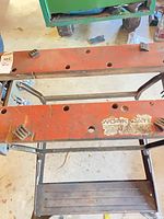 Top view showing red wooden jaws with dog holes and bench dogs