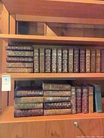 Full bookshelf view showing multiple rows of brown Reader’s Digest hardcover books