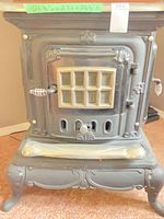 Front view showing overall form, front door with pane window, legs, and dimensions tag