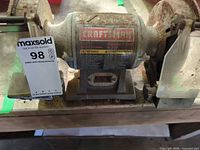 Front view of Craftsman bench grinder showing label and overall condition
