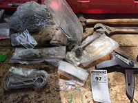 Bags of small hardware, unknown pistol-grip part, adjustable wrench end visible