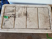 Top of Coleman cooler showing brand logo and scuffing