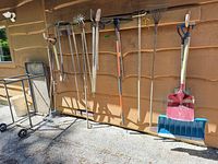 Overall view of tools hanging on wall with metal utility table
