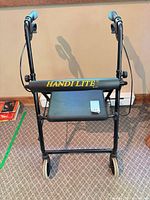 Front view showing Handi Lite branding, seat, wheels