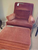 Front view of rust velvet armchair with ottoman