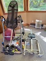 Full view of inversion table, rowing frame, exercise ball, dumbbells and accessories