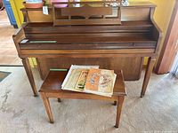 Full view of piano, bench and sheet music