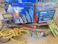 Overall lot showing boxed locking pliers, buffer/polisher, pipe wrench, rope, hoist, work light and fluids
