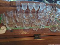 Full lot showing assorted clear glass pieces on trunk surface