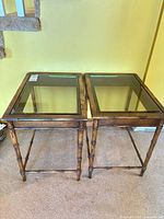Both matching faux bamboo end tables side by side