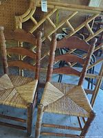 Front view of two ladderback chairs and headboard showing overall style and materials