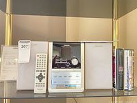 Front view of stereo unit, speakers, remote, DVDs