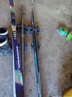 Two pairs alpine skis with bindings plus boots and accessories visible