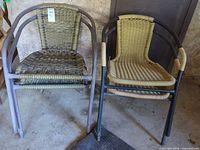 Two stacks of faux wicker patio chairs showing overall style and quantity