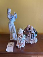 All three porcelain figurines on display surface