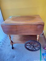 Full view of cart with leaf down showing wheels, shelf, drawer