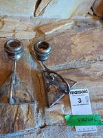 Pair of sterling silver candle holders top view showing triangular bases and tarnish