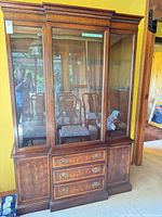 Full view of china cabinet showing glass doors, drawers, overall design