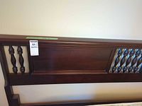 Front view of queen headboard showing dark mahogany finish and central panel
