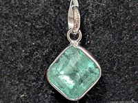 Front view of square Colombian emerald bezel-set pendant