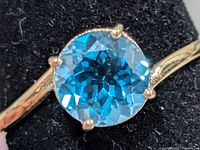 Close-up of blue topaz gemstone in setting