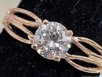 Close-up of round lab diamond solitaire in split-shank gold band