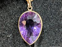 Front view of pear-shape amethyst pendant in bezel setting