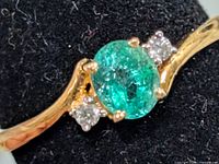 Top view showing emerald, diamonds, and gold band