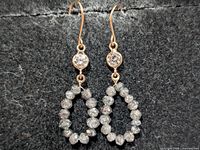 front view of earrings showing lab diamonds and bead diamond loops