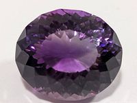 Front view of oval faceted amethyst showing brilliance