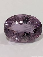 Top view of faceted oval amethyst showing brilliance and violet color