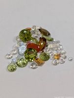 Pile of mixed gemstones on white background