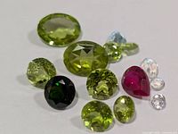 Group of faceted gemstones on white surface