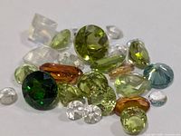 Close view of assorted faceted gemstones scattered for colour and cut visibility