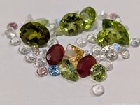 close-up of assorted loose gemstones spread on surface