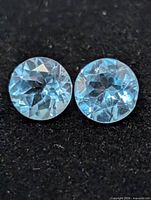 Close-up of both blue topaz stones showing faceting and color