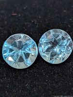 Close-up of both blue topaz stones showing color and faceting