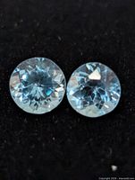 Close-up of both blue topaz gemstones showing color and cut