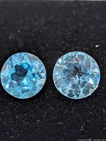 Close-up of both blue topaz stones showing facets and clarity