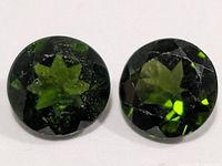 Front view of both round chrome diopside stones showing color and facets