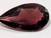 Pear-shaped faceted garnet gemstone front view