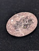 Close-up of oval pink morganite showing facets and inclusions