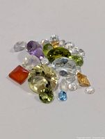 Loose multicolored gemstones on white background