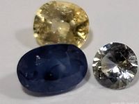 Three faceted sapphires in yellow, blue and grey tones