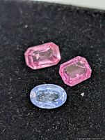 Two pink emerald-cut and one blue oval-cut sapphires totaling 1.65ct