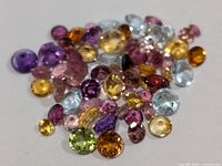 Group of assorted loose gemstones spread out