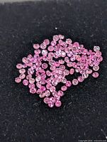 Loose pink sapphires spread on black foam
