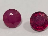 Close-up of two round faceted rubies