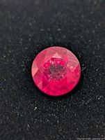 Close-up frontal view of the ruby showing colour and facet pattern